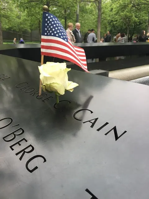 911 memorial with flag and flower for birthday of fallen