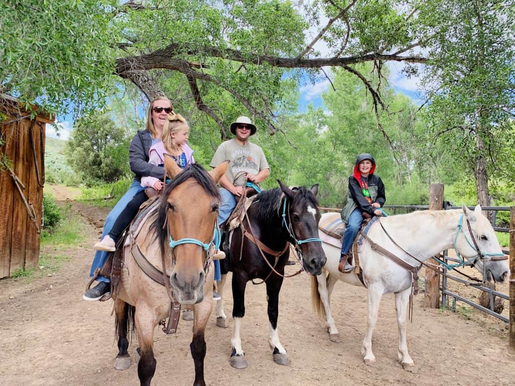 Family riding horses