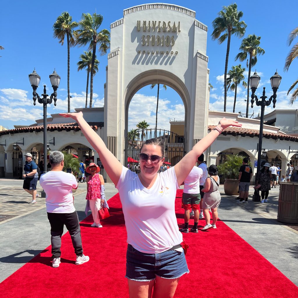 Lady posing in front of Universal Studios Hollywood sign